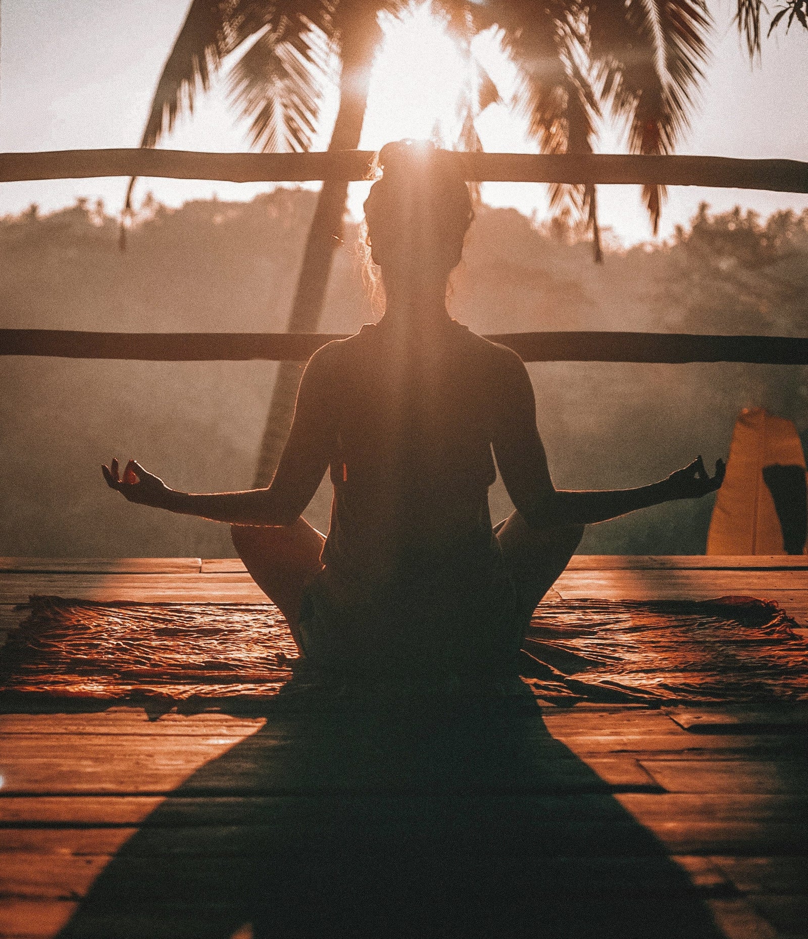 Person meditating at sunrise — how good health improves quality of life