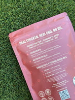 Cerberus Chews front of bag — three-headed dog mascot on a red cushion